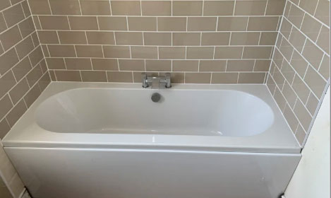 bath with beige tiles in Bristol